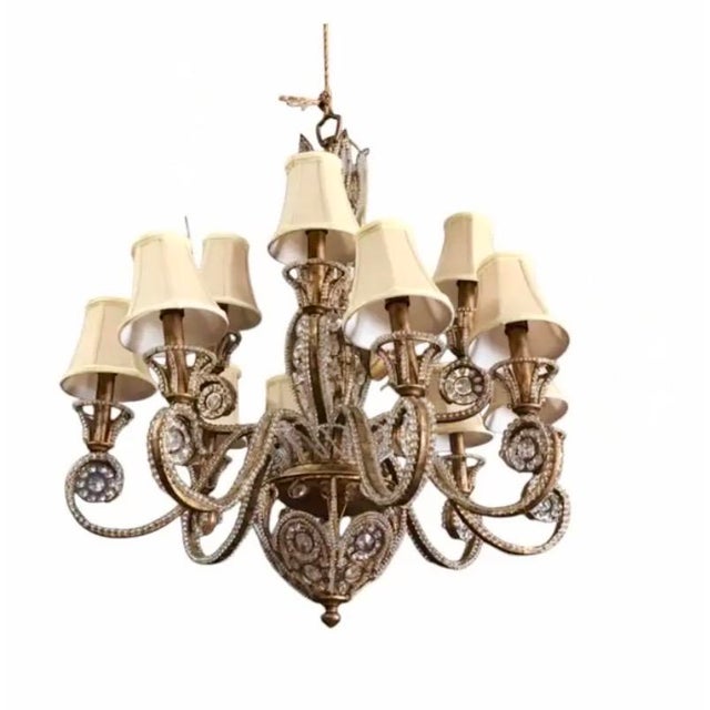 Beautiful, gilt-iron and crystal beaded chandelier. The chandelier consists of a scrolled iron frame with a gilt finish. A...