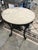 English Cast Iron "Brittania" Pub Table, 20th c., the ogee edge figured circular white marble top over a pierced skirt, on...