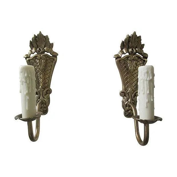 Pair of stunning handcrafted early-1900s Swedish Gustavian-style brass candle sconces with lattice detailing. Minor wear...