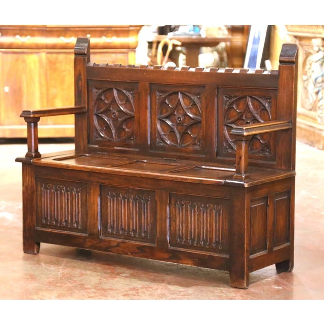 This handsome antique hall bench combines strong Gothic Revival architecture with practical concealed storage. Crafted in...
