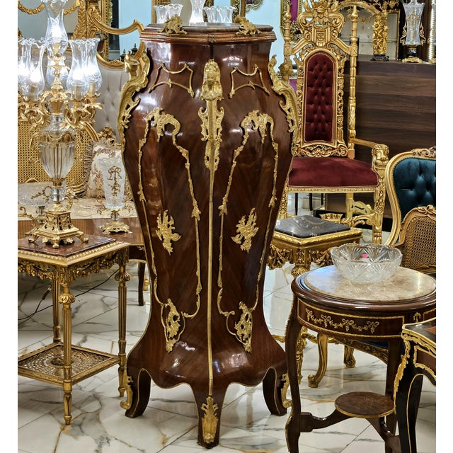 Make a dramatic statement with this exceptionally ornate French-style pedestal, featuring a rich polished dark wood...