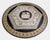 An extraordinary and highly decorative Italian round marble table dating from the early 20th century, featuring a...