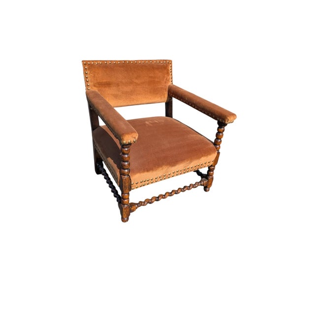A striking pair of vintage Jacobean Revival armchairs, hand-carved from solid oak with the classic barley twist (bobbin)...