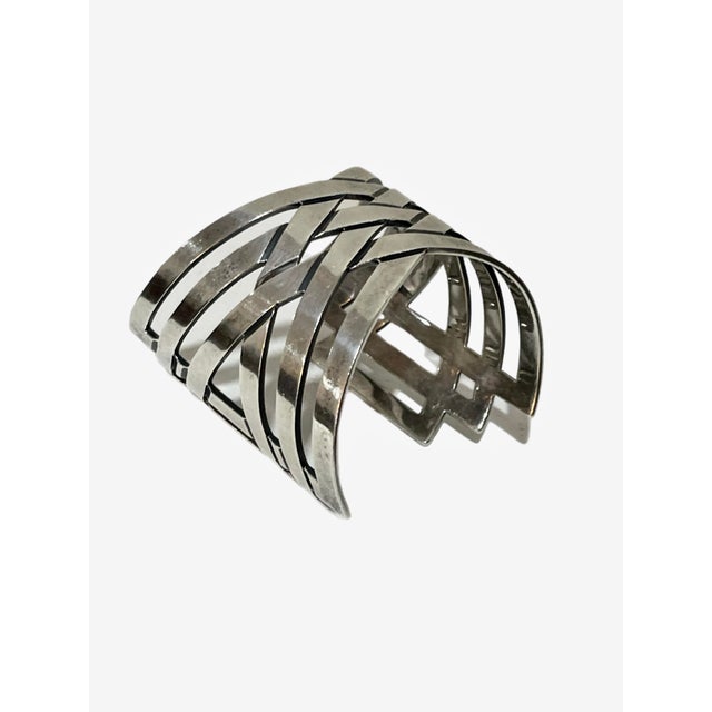 A striking Modernist bracelet with an angular woven, openwork design in sterling silver. Signed TH-55, 925 RHT Mexico....