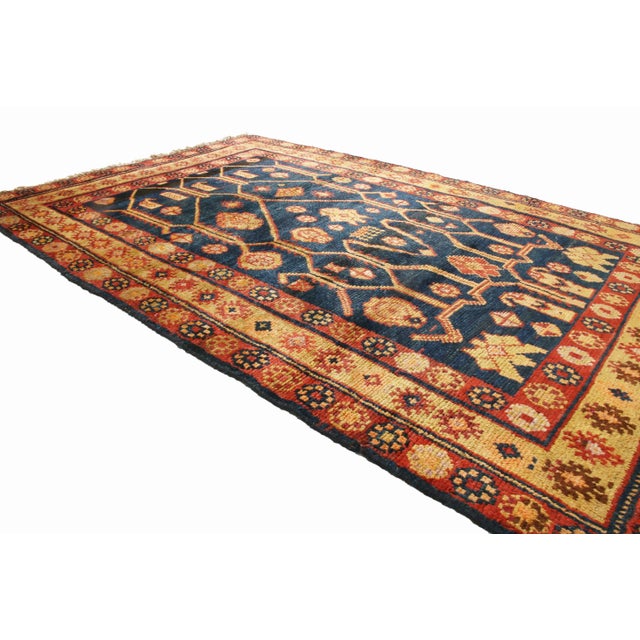 Originating from East Turkestan, this Vintage traditional Samarkand wool rug features a distinguished field design with an...