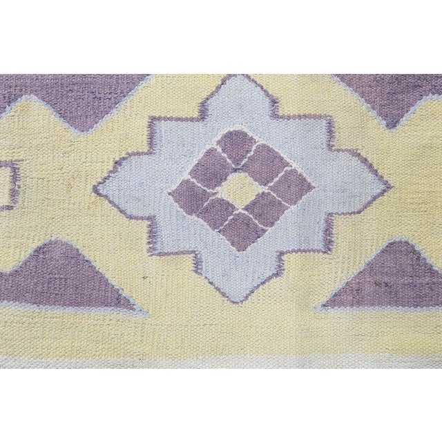 This charming vintage Indian Dhurrie rug, woven circa 1945, reflects the timeless appeal of India's traditional flat-weave...