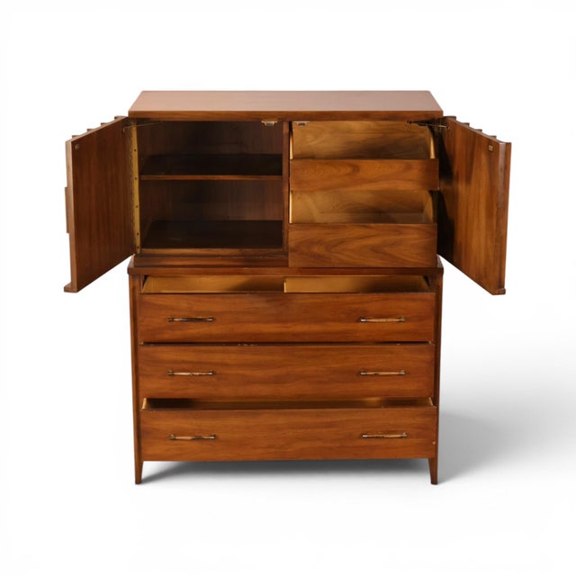 This 1960s Kent Coffey Perspecta gentlemen's highboy dresser shows the collection's signature blend of organic carving and...