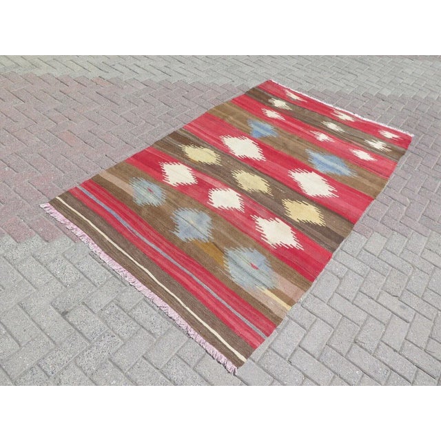 This beautiful, traditional vintage, flatweaved Turkish kilim is approximately 60 years old. It is handmade of very fine...