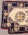 Chinese Wool Saddle Rug, in blue and cream with floral motif and red trim. 4' 6" L x 2' 1" W. Provenance: From a 45 East...