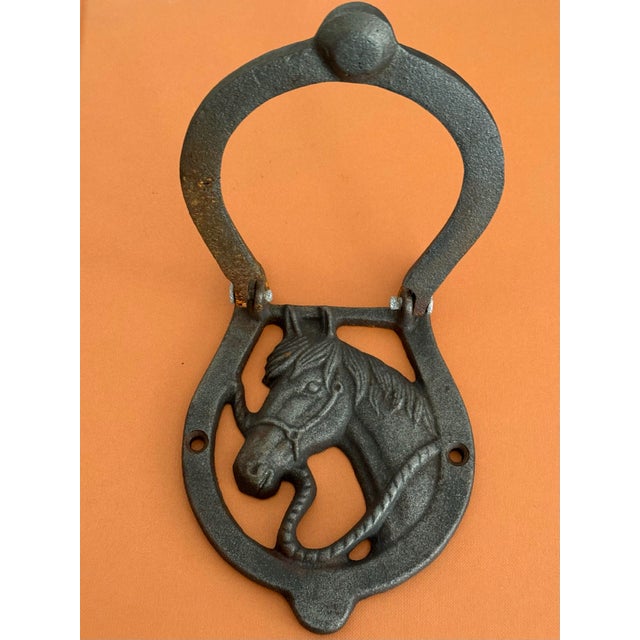 This cast iron door knocker features a sculpted horse head within a horseshoe knocker. It brings a bit of equestrian charm...