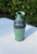 Vintage studio pottery vase featuring a softly rounded form, sculptural flared rim, and richly layered green, blue,...