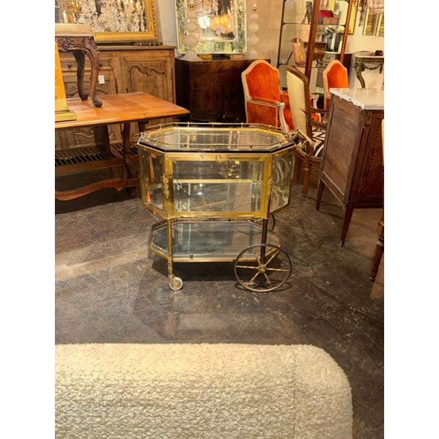 The Vintage French Gilt Brass Bar Cart is a luxurious addition to any home. This stylish piece of furniture features a...