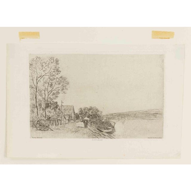 Etching and drypoint realized in 1890. The print depicts a serene riverside scene in Moret-sur-Loing, featuring a small...
