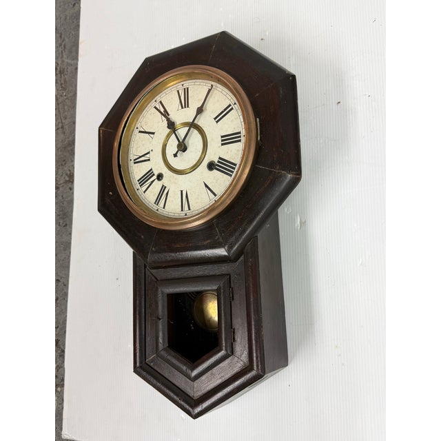 Design Plus Gallery presents an Antique Octagonal Drop Wood Wall Clock. This clock has an octagonal wood case, a round...