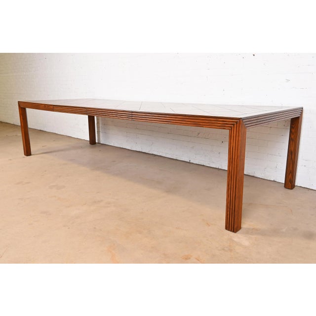 A gorgeous Mid-Century Modern Parsons extension dining table By Henredon USA, Circa 1970s Carved oak, with parquet top....