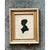 This vintage miniature portrait is a graceful profile silhouette of a woman facing left, cut in solid matte black paper...
