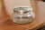 A small English glass vanity jar from the early years of the 20th century, with incised silver lid and etched design....