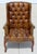 Add timeless character to your home with this vintage Chesterfield-style wingback armchair. Upholstered in rich brown faux...