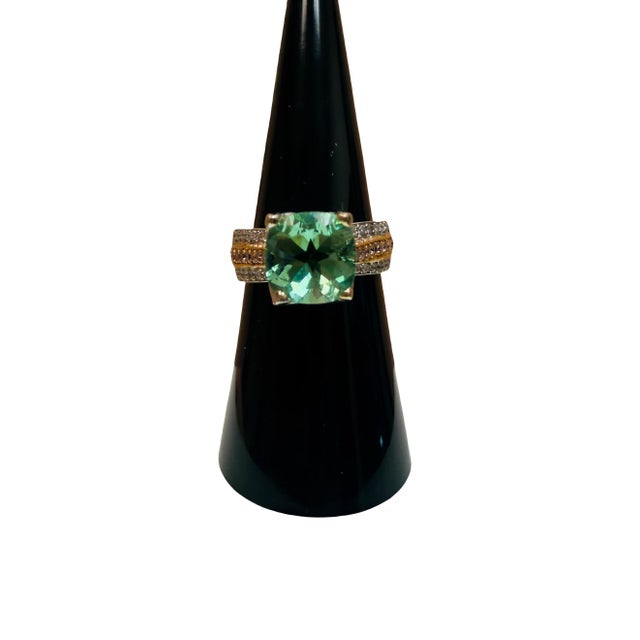 This exquisite statement ring masterfully blends vintage-inspired elegance with a modern, dynamic flair. The centerpiece...
