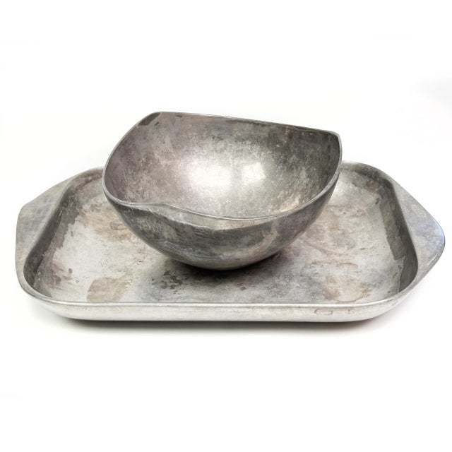 Beautiful pair of authentic Nambe mid-century modern serving pieces, crafted in Nambe’s signature sand-cast alloy. This...