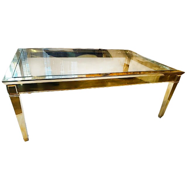 A charming Louis XVI Style coffee table. Brass frame and legs with a glass top. Bright polished finish. Made circa 1970....