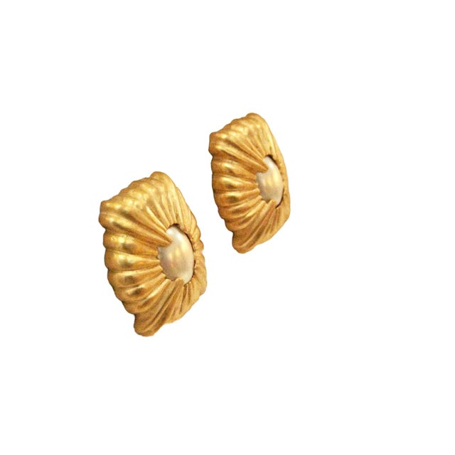 This is part of Chairish's Costume Jewelry Collection. 1970s Givenchy stunning vintage matte gold carved glass pearl clip...