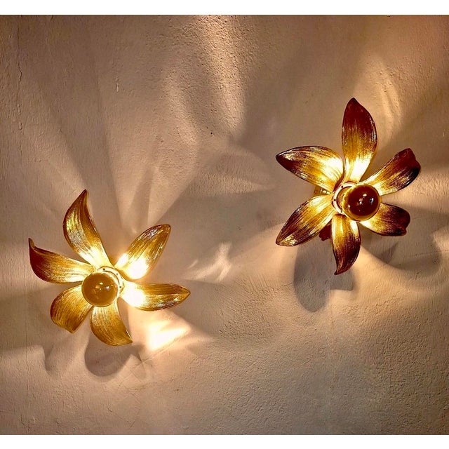 Elegant pair of wall or ceiling lights from the 1970s, France, two solid brass flowers with a finely structured finish....