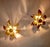 Elegant pair of wall or ceiling lights from the 1970s, France, two solid brass flowers with a finely structured finish....