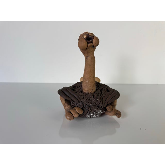 A delightful vintage art pottery sculpture in the playful style of Todd Warner, depicting a whimsically expressive ostrich...