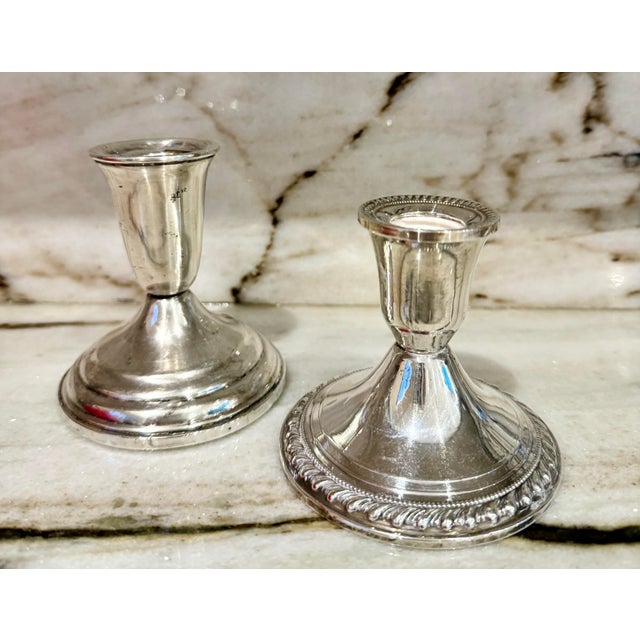 Pair of mismatched classic style Sterling Silver candle holder.marked on underside.
