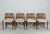 Construction made of varnished teak, each with vertically braced backrests and a padded seat upholstered in beige wool...
