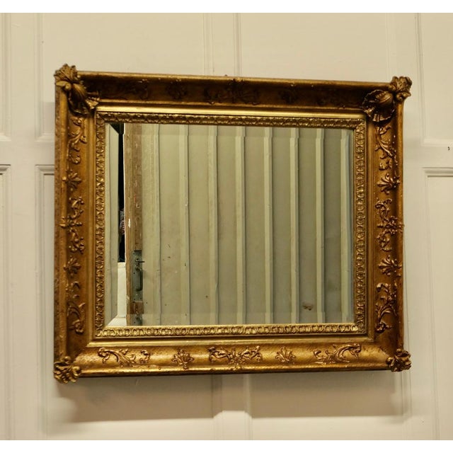Lovely square gilt rococo wall mirror. The mirror is in a Gilt Rococo Style Frame, it is almost square in shape with a 4”...