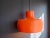 Mid Century Modern large hanging lamp. The lamp is made of 2 metal parts, the outer one is painted orange and the inner...