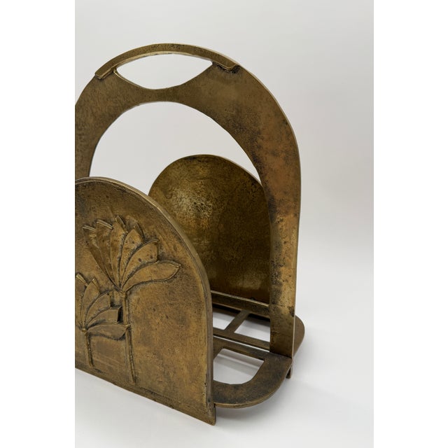 Made during the 1970s, this substantial brass magazine rack combines a broad arched structure with delicately rendered...