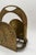 Made during the 1970s, this substantial brass magazine rack combines a broad arched structure with delicately rendered...
