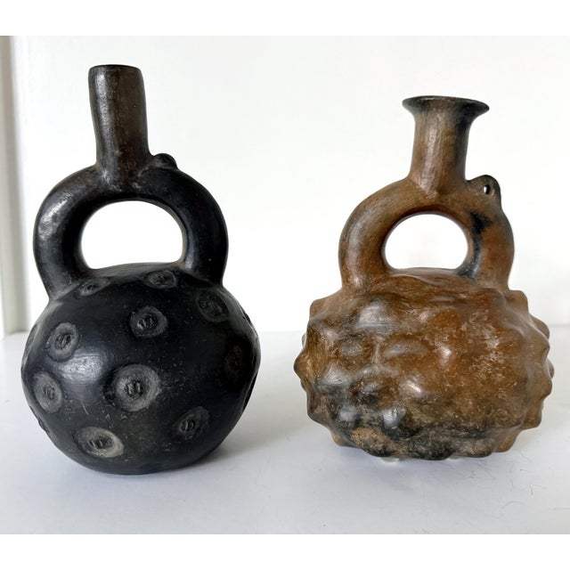A collection of two small pre-Columbian ceramic stirrup vessels in Cupisnique style circa 700-500BCE. These ancient...