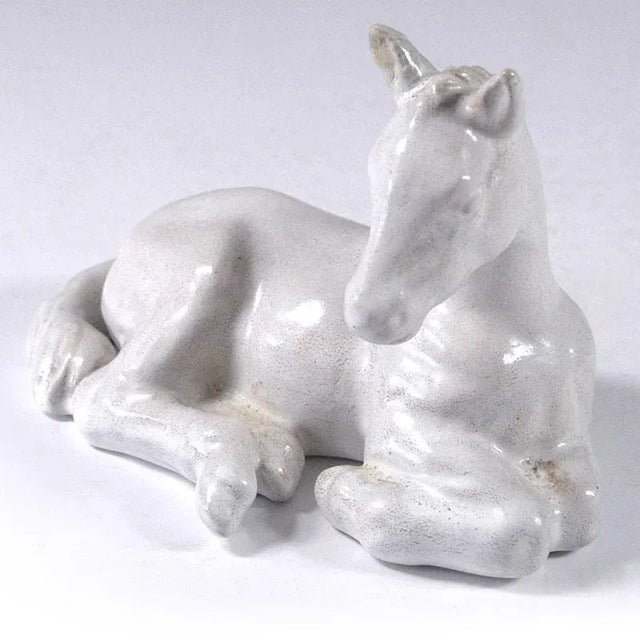 Danish, decorative figurine of lying foal made of glazed ceramics. Designed and made at Michael Andersen & Son, Bornholm....
