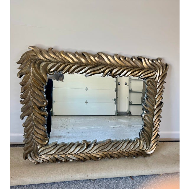 Stunning and heavy silvered modernist palm frond or acanthus leaf framed mirror composed of cast composite. (Color is...