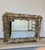 Stunning and heavy silvered modernist palm frond or acanthus leaf framed mirror composed of cast composite. (Color is...