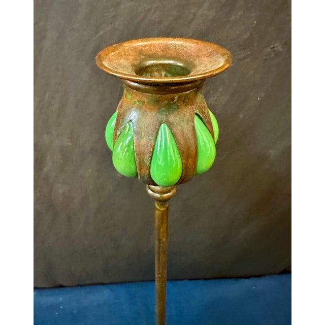 This vintage early 20th century authentic Tiffany Studios candlestick is decorated with blown out green color favrile art...