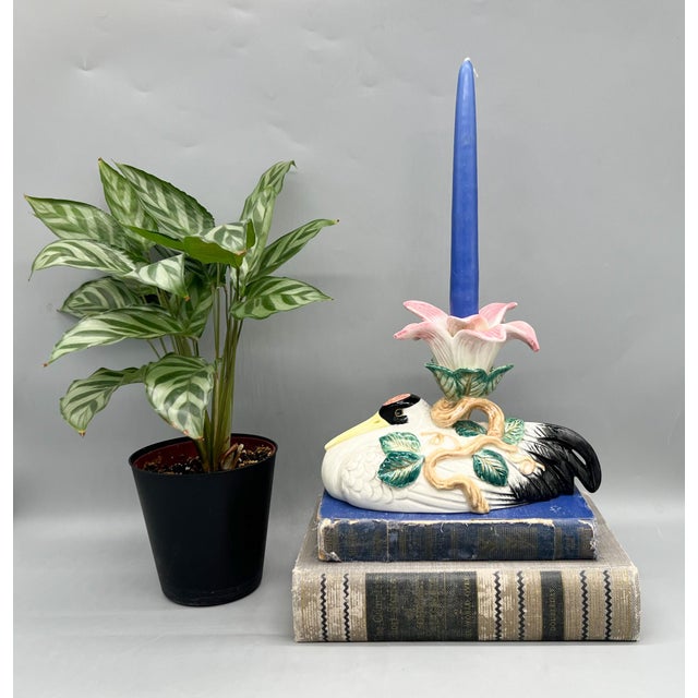 A beautifully sculptural 1996 Fitz & Floyd ceramic candlestick holder featuring a graceful crane beneath a blooming pink...