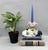 A beautifully sculptural 1996 Fitz & Floyd ceramic candlestick holder featuring a graceful crane beneath a blooming pink...