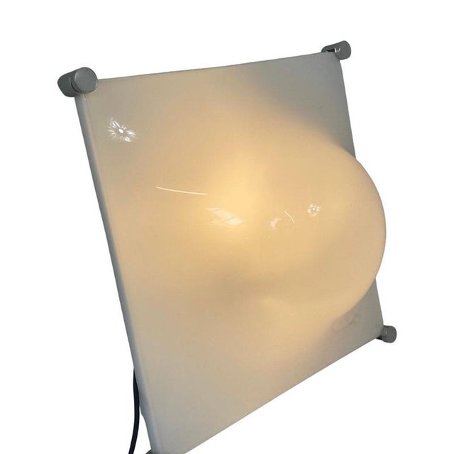 Space age design wall or ceiling mounted lamp. Made from white acrylic and a metal base. Can easily be mounted on any wall...