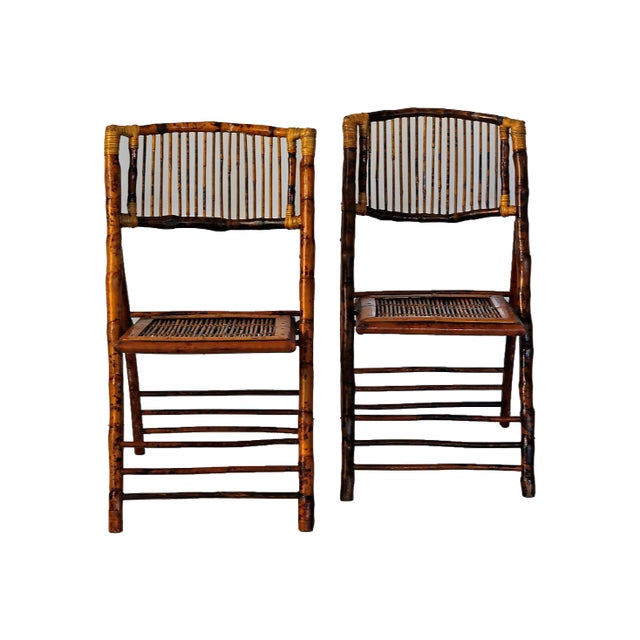 Pair of vintage bamboo and rattan folding chairs with faux tortoise shell painted finish. Dimensions folded:W:18.5" x...