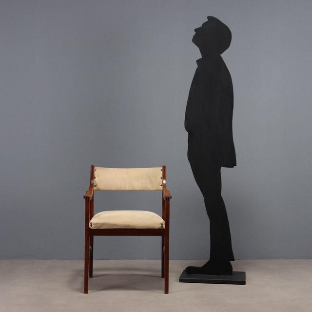 Chair with curved and stained beech wood frame, the padding is in foam, the upholstery is in fabric. This piece is...