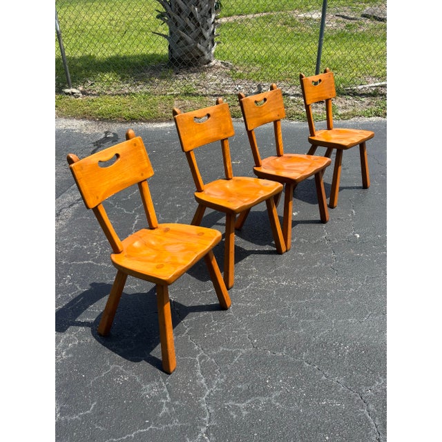 A handsome set of four authentic Cushman Colonial Creations dining chairs, crafted from solid maple in Bennington, Vermont...