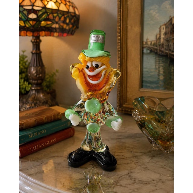 Whimsical vintage Italian art glass clown figurine by Tuscany, retaining its original “Tuscany Made in Italy” label. This...