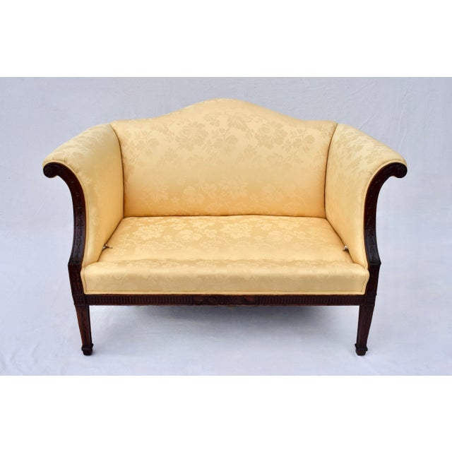 An early 20th c. diminutive Chippendale style Mahogany settee with plush goose down filled cushion and hand carved frame;...