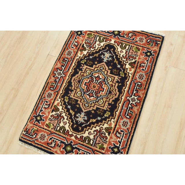 A traditional tribal Heriz rug hand-knotted with an all-wool pile on a cotton foundation. This oriental rug features a...