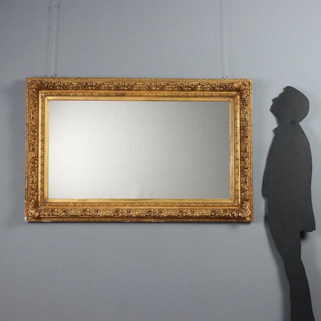 Mirror in carved and gilded fir and pastiglia. Frame decorated with floral and leaf carvings. Italy, early 20th century....